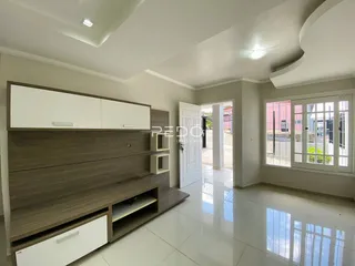 Sala de estar com piso de cerâmica e armários em madeira.