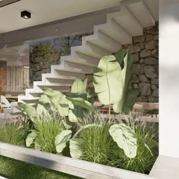 Jardim externo com vegetação verde e muros de pedra na propriedade.