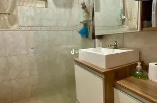 Foto do interior de um banheiro com revestimento cerâmico.