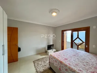 Quarto com paredes cinzas e cama de casal.