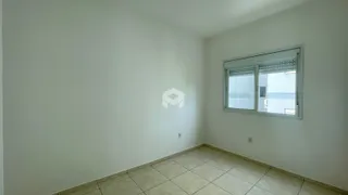 Vista interna de uma sala com paredes brancas e piso de cerâmica.