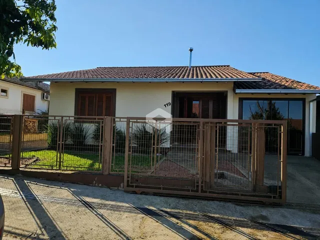 Fachada de uma casa em Lajeado, Brasil com cerca e portão de madeira.