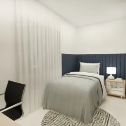 Quarto com cama e cabeceira azul em um ambiente claro.