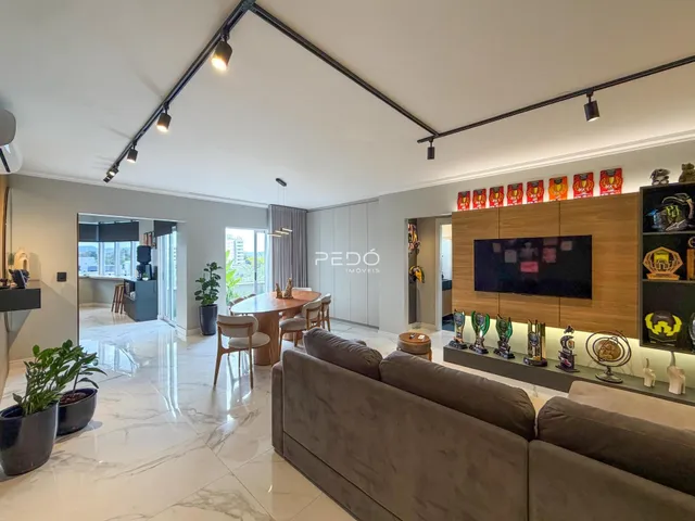 Sala de estar ampla com piso de mármore claro e móveis modernos.