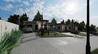 Vista externa da propriedade com área pavimentada e jardim.