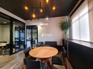 Ambiente interno com piso de madeira e mesa de jantar.