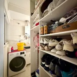 Prateleiras brancas com diversos itens de armazenamento em um ambiente interno.