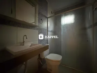 Banheiro com pia e box de vidro.