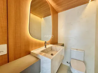 Banheiro moderno com bancada de mármore e revestimento de madeira.