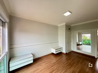Sala de estar com piso de madeira e paredes claras.