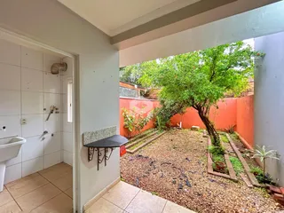 Hall de entrada com vista para o jardim externo de uma residência.