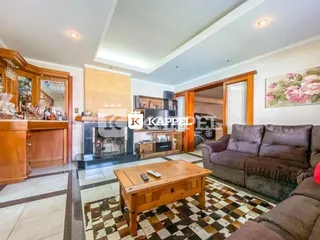 Sala de jantar com móveis de madeira e piso de cerâmica.