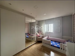 Quarto com armários brancos e piso de madeira.
