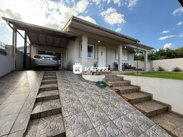 Fachada de uma casa em Lajeado, Brasil, mostrando a entrada e a área externa pavimentada.