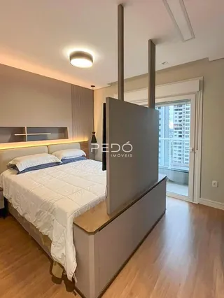 Quarto com cama e televisão em um apartamento.