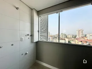 Parede interna de uma residência em Lajeado, Brasil, com uma grande janela de vista para a cidade.