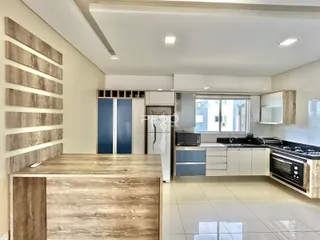 Imagem de uma cozinha moderna com armários brancos e piso claro.