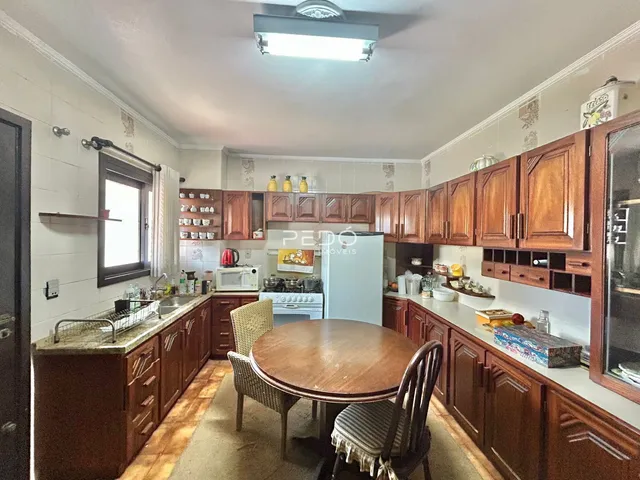 Interior da cozinha e sala de jantar de uma residência.