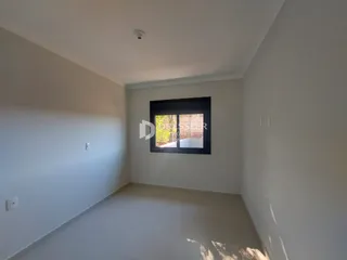 Vista interna de um ambiente com paredes brancas e piso claro.