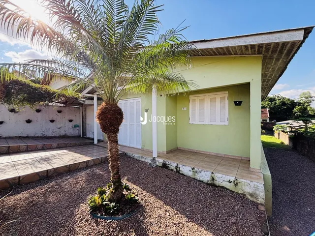 Fachada de uma residência em Lajeado, Brasil, com vegetação no primeiro plano.