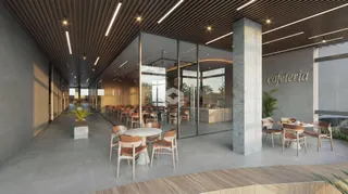Vista de um espaço de cafeteria com paredes de vidro e piso de concreto.