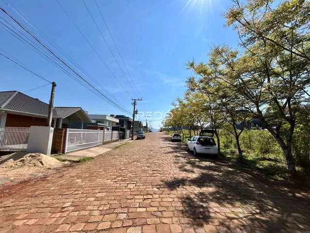 Vista da rua em Lajeado, Brasil, mostrando casas e vegetação.