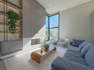 Sala de estar moderna com grande janela e decoração neutra.