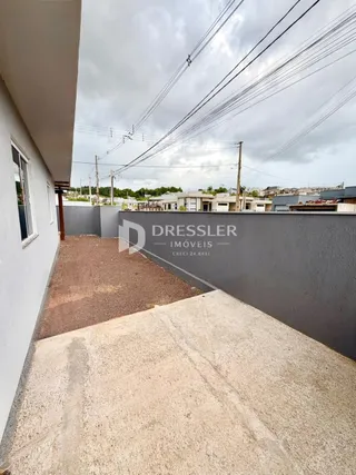 Fachada lateral de uma residência em Lajeado, Brasil, com muro e área pavimentada.