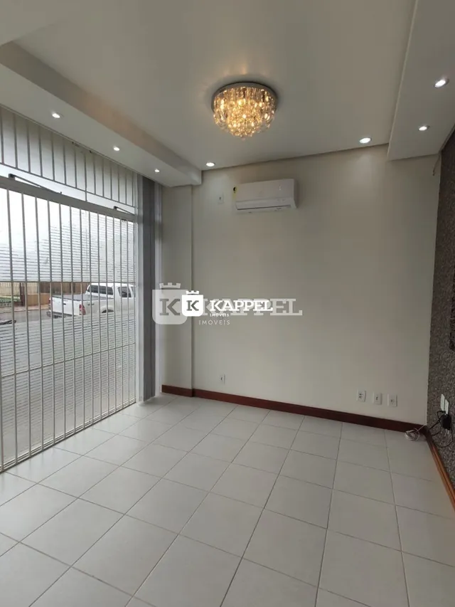 Sala de estar com piso de cerâmica e porta de vidro.