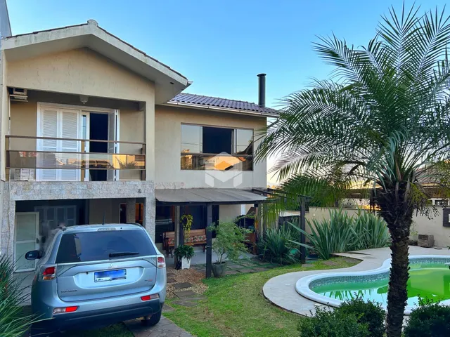 Fachada de uma casa em Lajeado, Brasil com jardim e piscina.