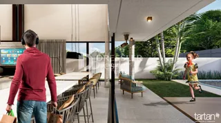 A sala de estar possui uma grande abertura para o exterior com vista para a vegetação.