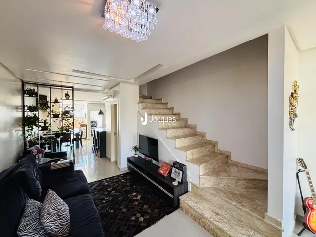 Sala de estar com escadaria e decoração moderna em Lajeado.