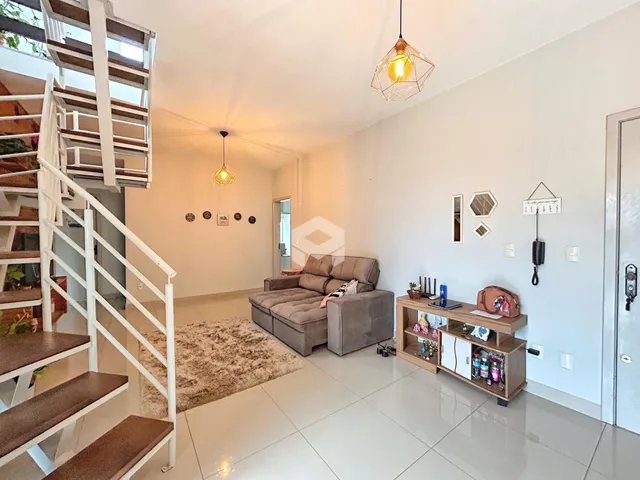 Sala de estar com piso claro e escadaria em um ambiente moderno.