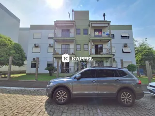 Fachada de um prédio residencial em Lajeado, Brasil, com varandas nos andares superiores.