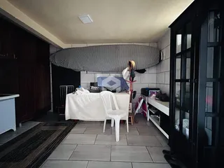 Interior de uma sala com móveis de madeira e piso de cerâmica.