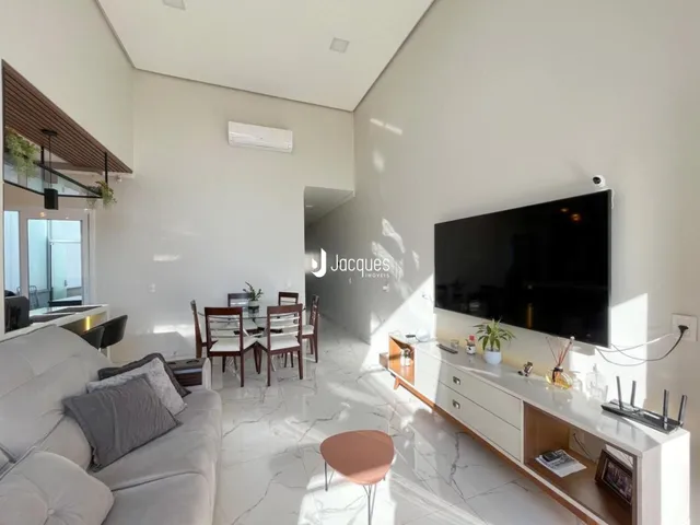 Sala de estar moderna com piso claro e decoração contemporânea.
