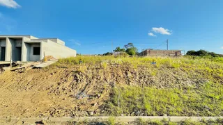 Vista externa de uma construção em terreno com vegetação rasteira.