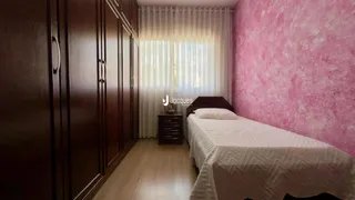 Quarto com armários de madeira escura e cama de casal.
