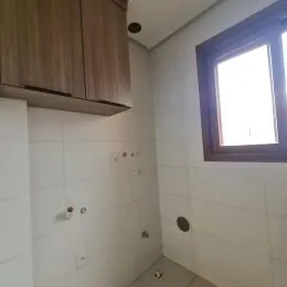 Vista interna de uma parede branca com janela em um ambiente residencial.