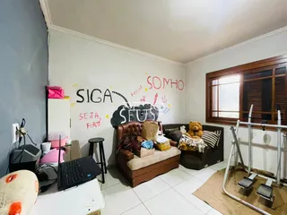 Sala de estar com sofá e decoração de parede em Lajeado.