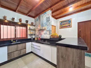 Foto de uma cozinha com armários e bancadas escuras em Lajeado.
