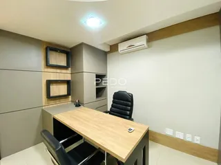 Ambiente de escritório com mesa e estante em um imóvel no Brasil.