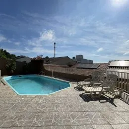 Foto de uma piscina externa com deck de pedra em uma propriedade.