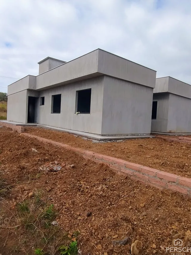 Fachada externa de uma casa moderna em Lajeado, Brasil, com fundação de tijolos aparentes.