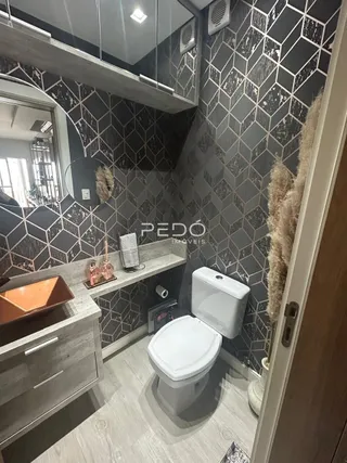 Foto de um ambiente interno com revestimento de parede e vaso sanitário.