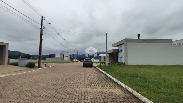 Vista da fachada de uma residência em Lajeado, Brasil, com entrada pavimentada e gramado.