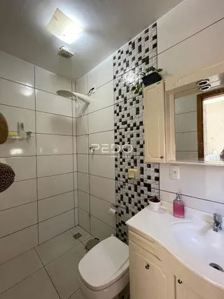 Foto de um banheiro com revestimento de azulejos brancos e pretos.