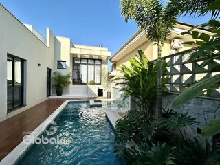 Vista da fachada de uma residência com piscina e jardim em Lajeado.