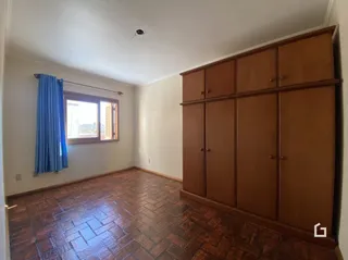 Interior de um cômodo com piso de madeira e painéis de madeira.
