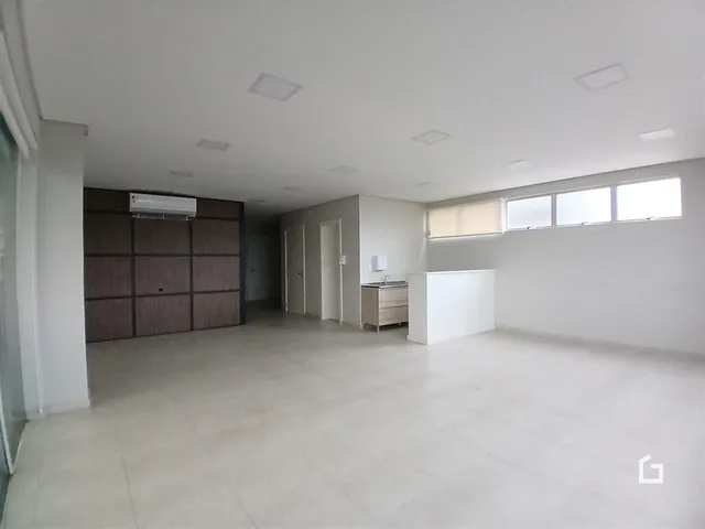 Hall de entrada com paredes brancas e piso de cerâmica.
